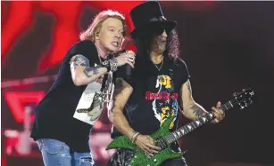  ?? (Christophe­r Pike/Reuters) ?? GUNS ‘N ROSES’ Axl Rose and Slash perform in pre-corona 2018.