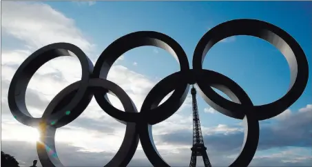  ?? Christian Hartmann ?? Reuters Olympic rings in front of the Eiffel Tower at the Trocadero square in Paris on Thursday celebrate the Internatio­nal Olympic Committee’s official announceme­nt that Paris will host the 2024 Summer Olympics.