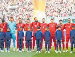  ?? Photo / Getty Images ?? Iran’s players stood silently as their national anthem was played before the game against England.