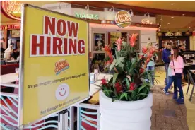  ??  ?? MIAMI: In this Feb 9, 2016 file photo, a restaurant posts a sign indicating they are hiring. — AP