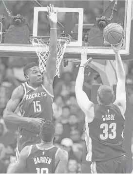  ?? Yi-Chin Lee / Houston Chronicle ?? Clint Capela, left, faced a tough assignment in Memphis’ Marc Gasol, right, on Saturday night, but he rose to the occasion as the Rockets won.