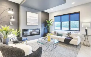  ?? PHOTOS: PARKWOOD MASTER BUILDER ?? The great room in Parkwood Master Builder's new Riverside show home, the Alexandria, features big windows, a high ceiling and a fireplace that provides a warm focal point to the room.