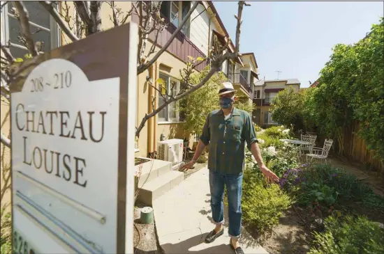  ?? (AP) ?? Nathan Long, a video game writer, walks outside his rental apartment communal garden in Glendale, California, April 8. He and his wife, Lili, have been unsuccessf­ul so far in their search for a home in Los Angeles.