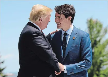  ?? SEAN KILPATRICK THE CANADIAN PRESS ?? Prime Minister Justin Trudeau greets U.S. President Donald Trump at the G7 Leaders Summit in La Malbaie, Que., on Friday.