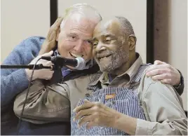  ?? STAFF FILE PHOTO BY ANGELA ROWLINGS ?? WORKING TOGETHER: Former Boston Mayor Raymond L. Flynn gives former state Rep. Mel King a hug at the launch of Boston Peace and Democracy Discussion­s in Roxbury last year.