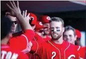  ?? PHOTO BY JOE ROBBINS — GETTY IMAGES ?? Zack Cozart (2) of the Cincinnati Reds celebrates with teammates after a solo home run against the San Francisco Giants in the fifth inning of a game at Great American Ball Park on in Cincinnati, Ohio. The Reds defeated the Giants 4-0.