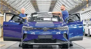  ?? REUTERS ?? Technical employees work in the final inspection at the production line for the electric Volkswagen model ID. 4, in Zwickau, Germany in this Sept. 18, 2020 file photo.