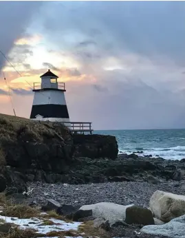  ??  ?? CINDY’S SNAPSHOT: Lynn Pulsifer captured this stunning sunset at Margaretsv­ille in Annapolis County NS. A ray of sunshine offers a bright backdrop for this lighthouse that stands on guard over the icy waters of the Bay of Fundy.