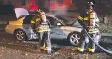  ??  ?? Matthew Johns (right) attends a car fire with a fellow firefighte­r. Dealing with crime is a big part of his job in the US.