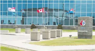  ??  ?? Flags fly at half mast at 15 Wing Moose Jaw on Monday following the death of Capt. Jenn Casey on the weekend.