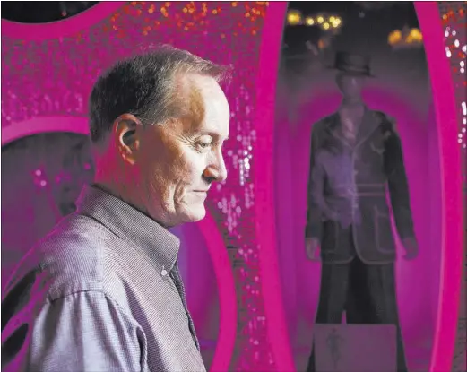  ?? JEFF SCHEID/LAS VEGAS REVIEW-JOURNAL FOLLOW @JLSCHEID ?? Dennis McBride, head of the Nevada State Museum, stands beside a Las Vegas production costume display at the museum.