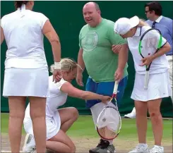  ??  ?? Clijsters helping Chris into the famous ‘skort’ at Wimbledon.