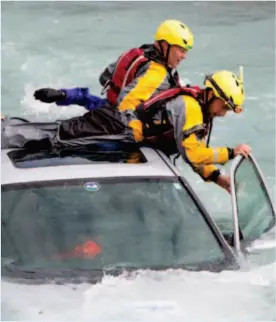  ?? CP PHOTO ?? TO THE RESCUE — Emergency personal from across western Canada take part in a vehicles in water training exercise in Pemberton on Wednesday.
