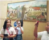  ?? Photo: REUTERS ?? Catholic schoolchil­dren take photos in a chapel dedicated to Saint Junipero Serra in Los Angeles. Pope Francis’ canonisati­on of the 18th-century missionary has been opposed by Native Americans.