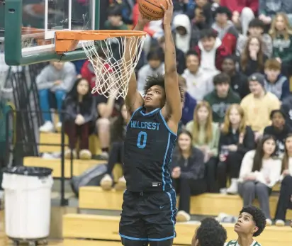  ?? VINCENT D. JOHNSON/DAILY SOUTHTOWN PHOTOS ?? Hillcrest’s Darrion Baker goes in for a dunk against Evergreen Park on Friday.