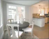  ??  ?? The dining area, with its hardwood floors and natural light, opens to the kitchen and living room.