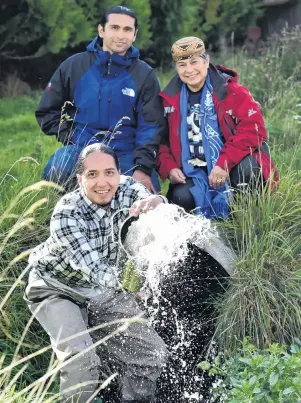  ?? PHOTO: PETER MCINTOSH ?? The voice of the salmon . . . Winnemem Wintu tribe member Nicholas Wilson tips a bucket of water outside the Hakatarame­a Valley hatchery where California­n McCloud River chinook salmon were first introduced to New Zealand. His cousin, Michael Preston...