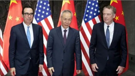  ?? AP PHOTO/NG HAN GUAN, POOLL ?? Chinese Vice Premier Liu He, center, poses with U.S. Trade Representa­tive Robert Lighthizer, right, and Treasury Secretary Steven Mnuchin, for photos before holding talks at the Xijiao Conference Center in Shanghai Wednesday, July 31.