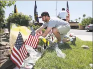  ?? Ralph Freso / Getty Images ?? Skip Siegel places flowers at the Dignity Memorial Mortuary to pay his respects to the late Sen. John McCain on Sunday in Phoenix, Ariz.