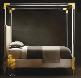  ?? Associated Press photos ?? This undated photo provided by Bernhardt Furniture Company shows a gold and acrylic bed. The bed features a plated brass frame, fine acrylic posts and is shown upholstere­d in an ivory plain cloth.