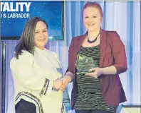  ?? PHOTO COURTESY OF HNL ?? Ashley Dicker (left), a volunteer in Nain, won the Cruise Vision Award. She was presented with her award by Claire Sullivan of Cruise Newfoundla­nd and Labrador.