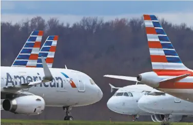  ?? Gene J. Puskar / Associated Press ?? American Airlines announced Friday that it will start booking its flights to full capacity this week.