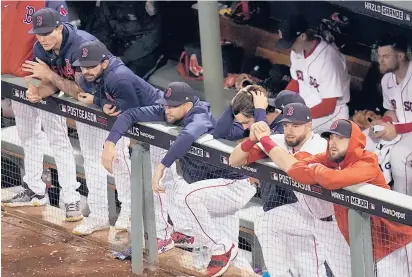  ?? CHARLES KRUPA/AP ?? Members of the Red Sox watch during the sixth inning in Game 5 of the ALCS against the Astros on Wednesday in Boston. The Red Sox lost 9-1, putting them one loss from losing the series.