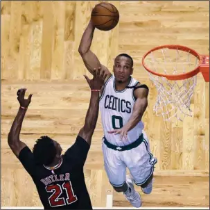  ?? The Associated Press ?? ZEROED IN: Boston guard Avery Bradley (0) lines up a dunk over Chicago forward Jimmy Butler during the fourth quarter of the Celtics’ 108-97 victory Wednesday night in Game 5 of their NBA firstround playoff series.