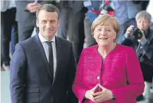  ?? BLOOMBERG ?? New French president Emmanuel Macron and Angela Merkel, Germany’s chancellor, meet in Berlin on Monday.