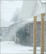  ?? Westside Eagle Observer/MIKE ECKELS ?? Wind gusts of 30 miles an hour blow snow off a roof in Springdale Thursday afternoon as powerful and deadly winter storm Elliot moves through northwest Arkansas.