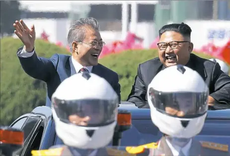 ??  ?? South Korean President Moon Jae-in, left, and North Korean leader Kim Jong-un ride in a car parade Tuesday in Pyongyang, North Korea. Mr. Kim and Mr. Moon met for a historic peace summit.