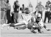  ?? MIKE EHRMANN/GETTY IMAGES ?? Florida State’s Levonta Taylor breaks up a pass intended for Miami’s Malcolm Lewis during the 2016 season.