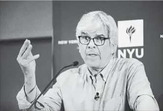  ?? SPENCER PLATT GETTY IMAGES ?? New York University professor Paul Romer speaks at a news conference Monday after being named a winner of the 2018 Nobel Prize in economics. He says he’s optimistic society can solve the global warming threat.