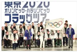  ??  ?? Tokyo governor Yuriko Koike waves the Olympic flag during a ceremony marking three years to go before the start of the Tokyo 2020 Olympic Games at the Tokyo Metropolit­an Assembly Building on Monday. (AFP)