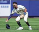  ?? MATT YORK / AP ?? Outfielder Jackson Chourio fields a base hit by Texas' Justin Foscue during a spring training game last Saturday in Phoenix. Chourio's defense has been a concern for the Brewers this spring.