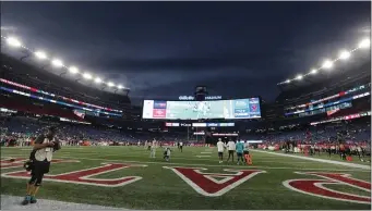  ?? AP PHOTO/MICHAEL DWYER, FILE ?? Lights illuminate Gillette Stadium before an NFL football game between the New England Patriots and the Miami Dolphins Sept. 17, in Foxborough, Mass. One of two Rhode Island men charged with assault and battery and disorderly conduct in connection with the death of a fan at a New England Patriots game pleaded not guilty Friday.