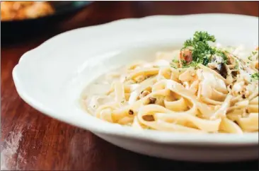  ?? GETTY IMAGES ?? The popular fettuccine takes on many forms including, as seen here, with shrimp, mushrooms and white cream sauce.