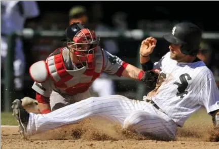  ?? PAUL BEATY - THE ASSOCIATED PRESS ?? Chicago White Sox’s Kevan Smith, right, slides safely into home plate on a Melky Cabrera single while Boston Red Sox catcher Christian Vazquez tries to apply the tag during the seventh inning of Chicago’s 5-4 win.