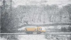  ??  ?? 0 A snow plough grits the M74 as significan­t snowfall is forecast