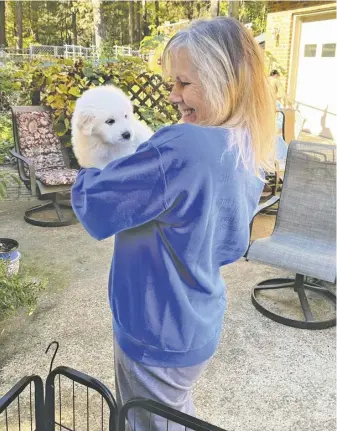  ?? COURTESY PHOTO ?? Donna LeCompte-McConn with a Great Pyrenees puppy.