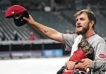  ?? Tony Dejak / Associated Press ?? Reds lefthander Wade Miley tips his cap to fans after pitching his first career no-hitter against the Cleveland Indians.