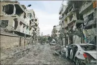  ?? BASSAM KHABIEH / REUTERS ?? Damaged buildings are seen in the besieged town of Douma, Eastern Ghouta, Syria, on Sunday.