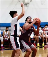  ?? RECORDER PHOTO BY
NAYIRAH DOSU ?? Granite Hills High School’s Adam Sandoval, right, looks to shoot while Strathmore’s Manuel Andrade defends, Wednesday, April 14, 2021, during a basketball game at Strathmore.