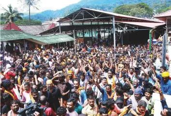  ?? PTI ?? Devotees protest as several women devotees arrive to offer prayers at Sabarimala temple in the light of the recent verdict by Supreme Court allowing entry to women of all ages.