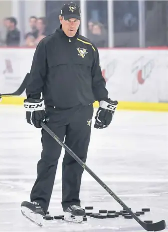  ?? Matt Freed/Post-Gazette ?? Penguins coach Mike Sullivan watches over the first day of training camp Friday at UPMC Lemieux Sports Complex in Cranberry.