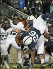  ?? CHRIS KNIGHT — THE ASSOCIATED PRESS FILE ?? Penn State’s Saquon Barkley (26) dives over the pile for a touchdown against Michigan State in the first half of an NCAA college football game in State College, Pa. Barkley struggled against Michigan State last year and this week is coming off a...