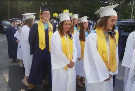  ?? Photo by Joseph Fitzgerald ?? Graduates file into the Levy Rink before the start of Burrillvil­le High commenceme­nt.