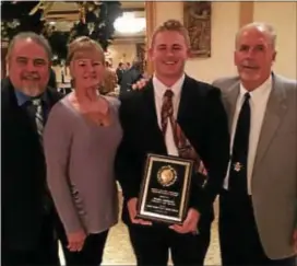  ?? SUBMITTED PHOTO ?? Interboro football player Wyatt McDevitt, second from right, displays the Martin Kennedy Memorial Scholar-Athlete Award that he received from the Chester Chapter of PIAA Football Officials. With him are, from left, parents, Leonard and Carrie McDevitt,...