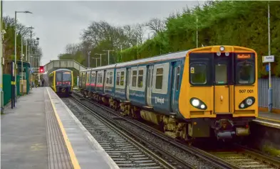  ?? Kevin Delaney ?? Subject to a preservati­on attempt by the Class 507 Preservati­on Society, pioneer Merseyrail Class 507 electric multiple unit 507001 prepares to depart from Freshfield station with a Hunts Cross to Southport service on December 20, 2023, while Stadler 777010 heads in the opposite direction. The Class 777s are expected to completely take over services on the Merseyrail network during 2024.