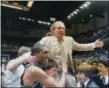  ?? THE ASSOCIATED PRESS ?? In this March 24, 1985 file photo, Villanova coach Rollie Massimino takes a victory ride on his players shoulders. Massimino led Villanova’s storied run to the 1985 NCAA championsh­ip.